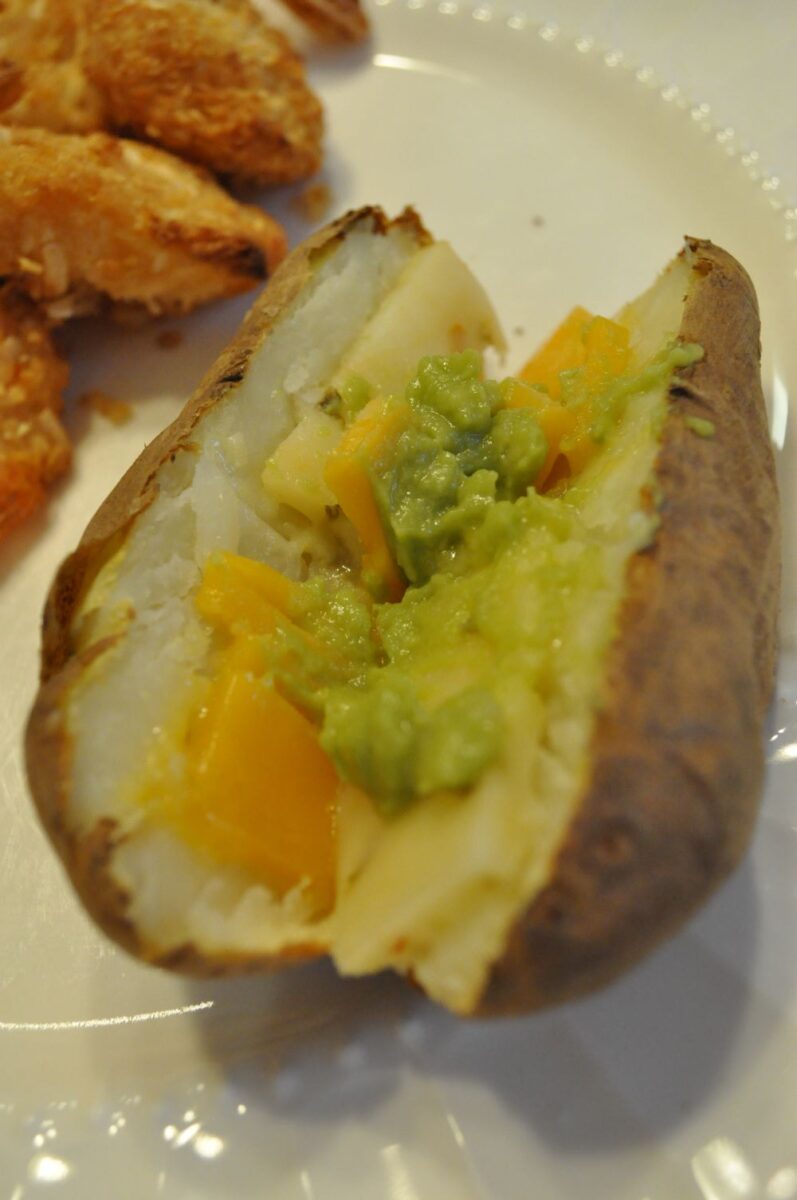 Baked potato with butter, cheese, guacamole and sour cream.